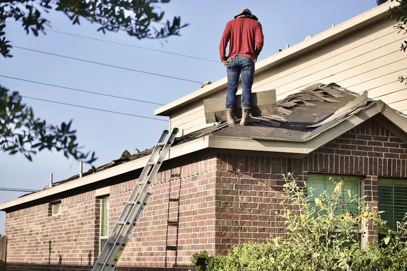 Professional roofer working on a residential roof in Clear Lake